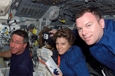 STS-114 Commander Eileen Collins, center, is joined on Discovery's flight deck by Mission Specialist Steve Robinson, left, and Pilot Jim Kelly. Credit: NASA